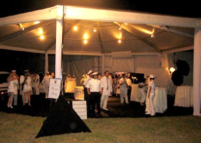 At the entrance to the tent, guests mingled around cocktail tables covered in faux white fur, and had their pictures taken against a white backdrop.