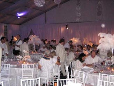 David Johnson of A Basket Affair created a white wonderland for the event, with white chairs, linens, draping, and white-feathered centerpieces.