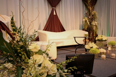 Posh furniture, elaborate floral arrangements, and an elegant backdrop created a unique stage set for Colin's main presentation.
