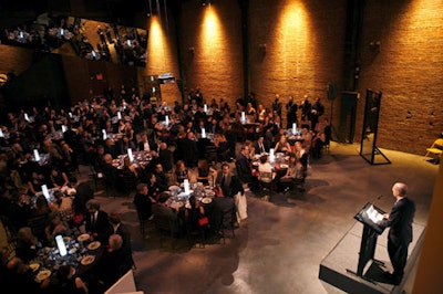 Benefactor Peter Stevens addressed dinner guests. Dotting the tables, LED centerpieces replaced candlelight in a symbolic gesture to Holzer.