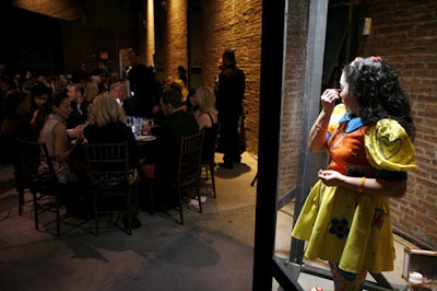 Models enacted Xavier Cha's performance piece behind two-way mirrors during dinner.