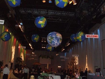 Globes and welcome signs in several languages hung from the ceiling in the silent auction room.