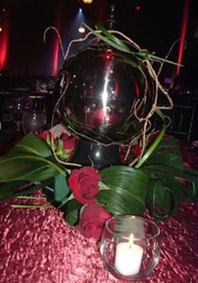 Globes filled with roses, crystal, and twisty vines served as centerpieces.