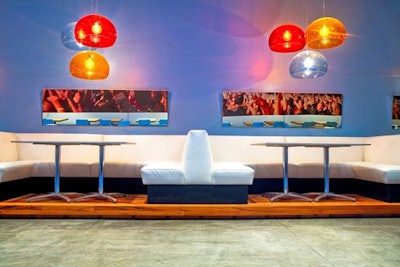 White booths with colorful dome light fixtures.