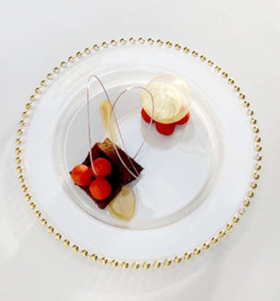 Chicago's Calihan Catering's moist honey ginger cake is a new twist on traditional spice cake. Pastry chef Pedro Gomez completes the dish with cider-poached apples, caramel sauce, and a 'snow globe' made of sugar and filled with vanilla ice cream.