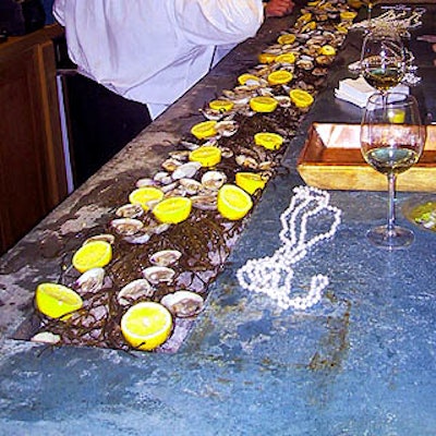 Esca's glittering raw bar featured raw clams on a bed of ice with lemons.