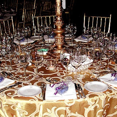 Victor's Garden District set each flower arrangement on gold pedestals on top of shimmering gold-patterned tablecloths.