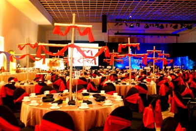 Each table featured a striking golden mast of a ship draped in a rich red fabric, creating an effect similar to an armada sailing out to sea.