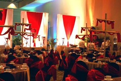 The 60-inch round tables were clad in black and red linens accompanied by chairs draped with coordinating fabrics to resemble the tattered clothing of a seafaring pirate.