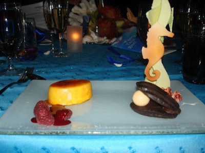 The evening's dessert was a trio of white chocolate cheesecake with a fruit glaze, chocolate flourless cake clamshell with a cognac truffle pearl, and a white chocolate airbrushed seascape complete edible coral and seahorse.