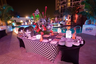 Catering stations provided by the Trump International Sonesta Resort were outfitted in black-and-white checkered stretch spandex and featured hubcap centerpieces and orange traffic cones.