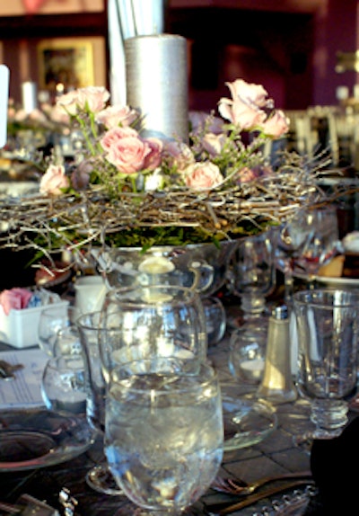 Ivy branches entwined with soft pink roses and lavender served as a romantic, low-profile centerpiece for each table.