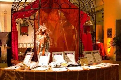 Silent-auction items were displayed atop tables surrounding a gazebo draped in silk.