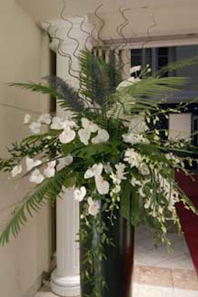 Dendrobium orchids in large boulevard vases flanked the entrance to the dining area.