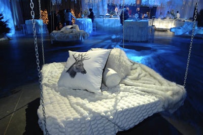 Stag-head pillows and faux fur throws dressed four floating beds suspended from the ceiling.
