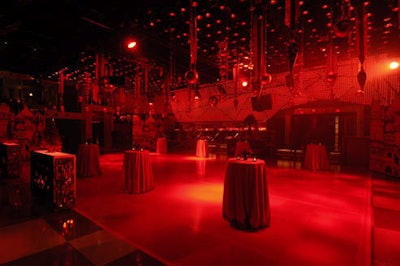 Oversize Christmas ornaments hung from the ceiling above a red dance floor.