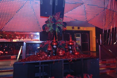 Plumes of black feathers mixed with red roses and greens in a floral arrangement supplied by San Remo Florists.