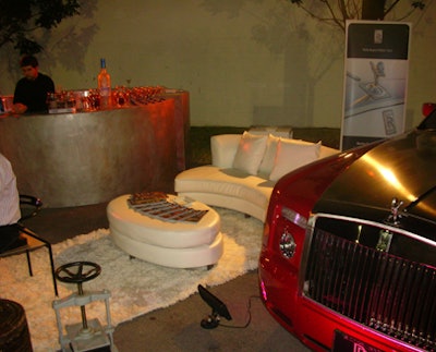 A red Rolls-Royce Phantom was parked next to the outdoor bar that served the evening's drink, the Artiste.