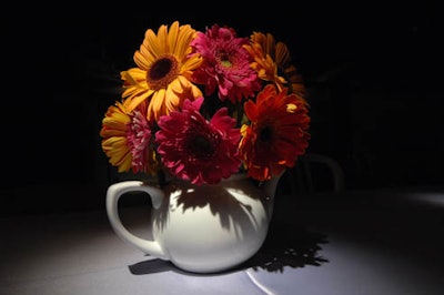 Teapots filled with gerbera daisies topped the 40-foot-long dining table.