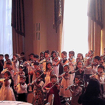 Children from Amelia Gold's Violin Camerata rehearsed before the dinner.