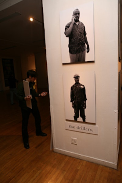 Black-and-white images of workers who built wells with funds raised by Charity: Water donations appeared throughout the space.