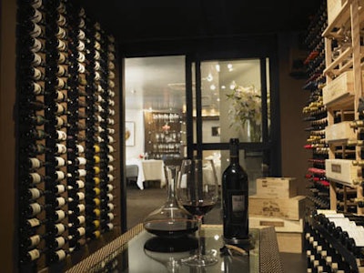 A wine room holding more than 450 bottles connects the dining room to the tasting room.