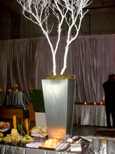 White, leafless trees set in tall metallic gray planters added a wintry elegance to the buffet tables.