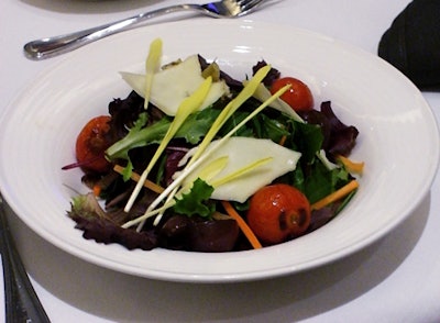 The first course featured a salad of baby greens, fontina, charred tomatoes, artichokes, and balsamic-glazed onions.