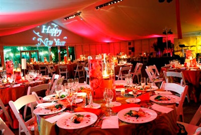 The celebration tent was outfitted with colorful lighting and festive decor elements, including a special New Year's message projected above the entry.