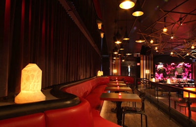 Elevated red leather banquette seating provides an unobstructed view of the stage.