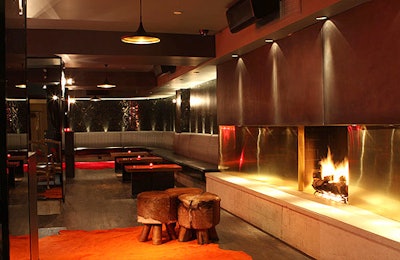 A fireplace, surrounded by brass and steel, serves as a focal point on the lower level.