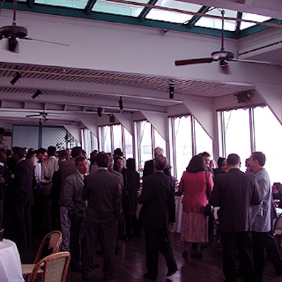 Guests mingled in the Water Club's banquet room, with its large windows looking out on the East River.
