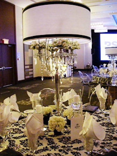 Tall lamps, with small bouquets of white roses paced inside the lampshades, served as centrepieces.