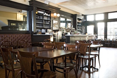 The downstairs dining room, with dark wood banquettes and long mirrors, seats 72.