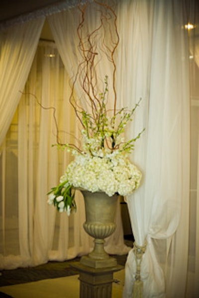 Tall urns filled with white tulips and hydrangeas sat at the entrance to the private lounge.