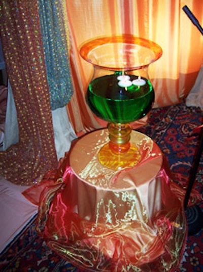 Large vases filled with green liquid and floating tea lights were part of the colourful stage decoration.