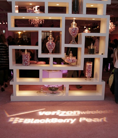 Candy jars on a white shelving unit made a bold centerpiece in the entryway.