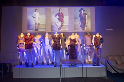 Four vignettes in the main space displayed the new collections, while screens above showed photographs of models wearing the clothes.