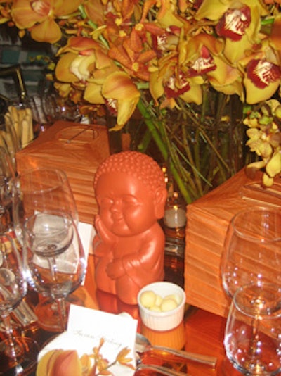 Architect and designer Campion Platt's all-orange setting included Buddha statues as well as paper lanterns, fans, chopsticks, and a mirrored dining surface.