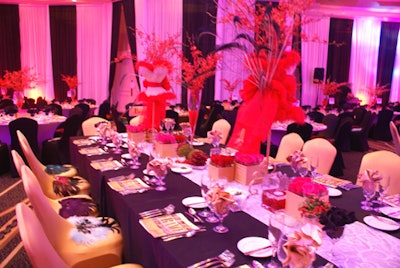 In the main ballroom, guests were transported to a classic Parisian-style boudoir setting, complete with a dramatic color scheme of black, gold, and rouge.