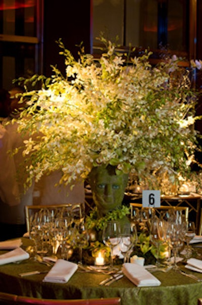 A bust of Persephone filled with a plethora of green and white orchid stems made a striking centerpiece at Richard Keith Langham's table.