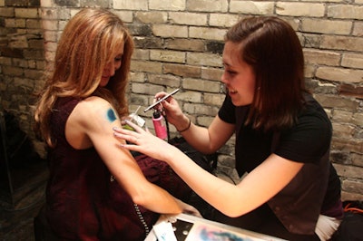 A tattoo artist from Black Line Studio airbrushed guests with temporary tattoos of their choice.
