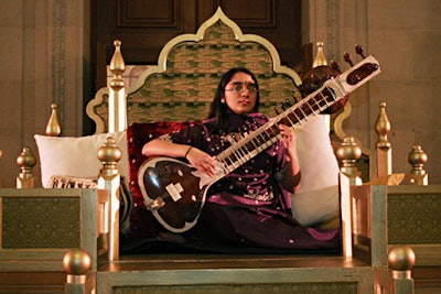 A sitar player sat at the venue's entrance.