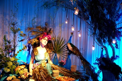 A peacock-dressed model lounged on one of the tables holding gourmet treats from Mise en Place.