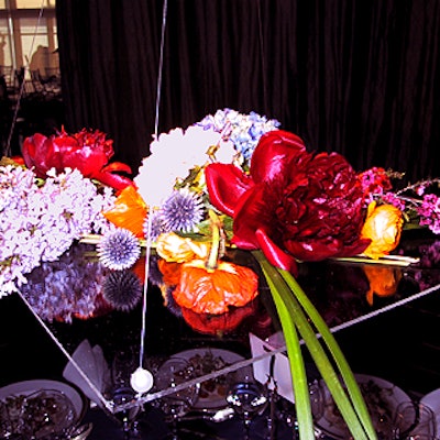 For the centerpieces at the Public Art Fund's gala at the Lighthouse at Chelsea Piers, Connie Sherman of Wink Studio suspended clear acrylic sheets covered with flowers from the ceiling with fishing wire.