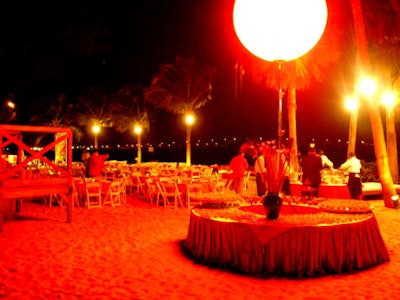 Tiki torchs lit the walkway to the beach-the main event setting--that was illuminated with red lights, courtesy of Southern Audio Visual, and scattered with tables draped in red, the color of good luck, provided by BBJ Linen.