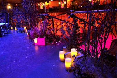 The design team scattered pillar votive candles throughout the venue to add to the dramatic lighting.