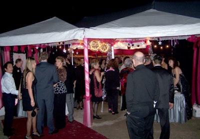 Inside the tent constructed by St. Augustine Tent Rentals, Sight and Sound Productions drenched the walls with pink lighting, the signature breast cancer awareness color.