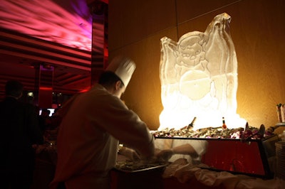 An ice sculpture of a devil towered over the buffet, which included couscous, cheese, and chocolate-covered strawberries.