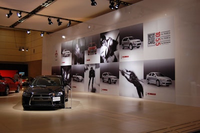 A wall of black-and-white action shots, part of Mitsubishi's latest ad campaign, took on the look of an art gallery.